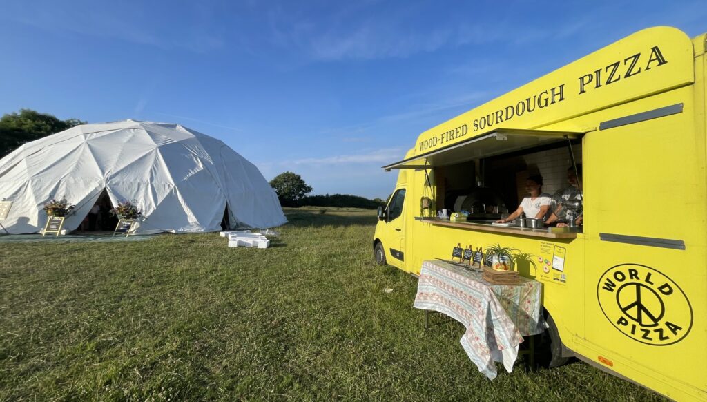 Woodfired pizza van catering at outdoor wedding reception in Plymouth Devon with guests enjoying authentic Neapolitan pizza